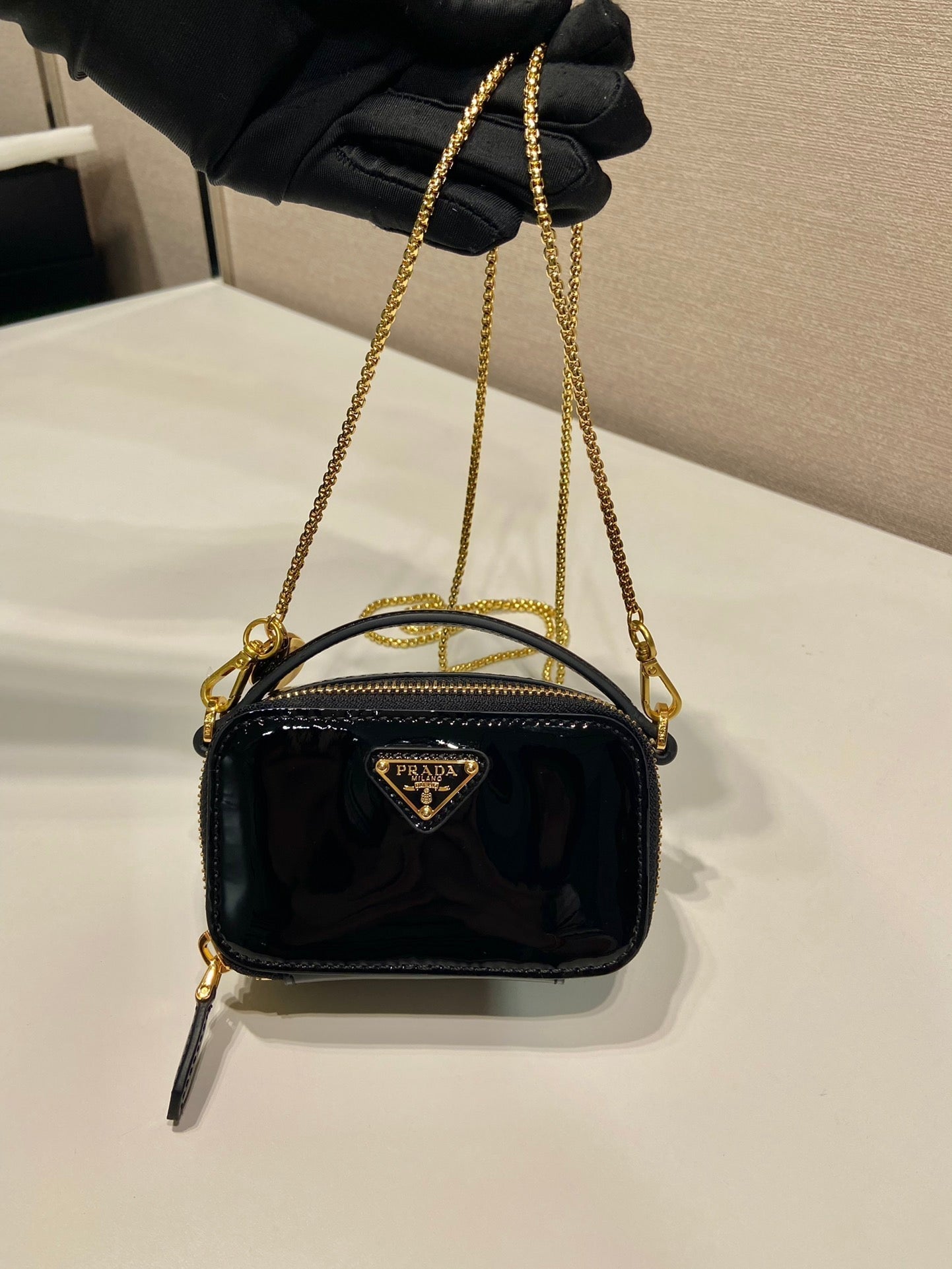 MINI HAND BAG 11 WITH GOLD STRAP IN BLACK PATENT CALFSKIN