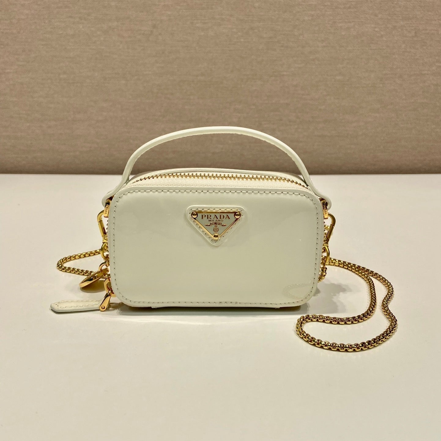 MINI HAND BAG 11 WITH GOLD STRAP IN WHITE PATENT CALFSKIN
