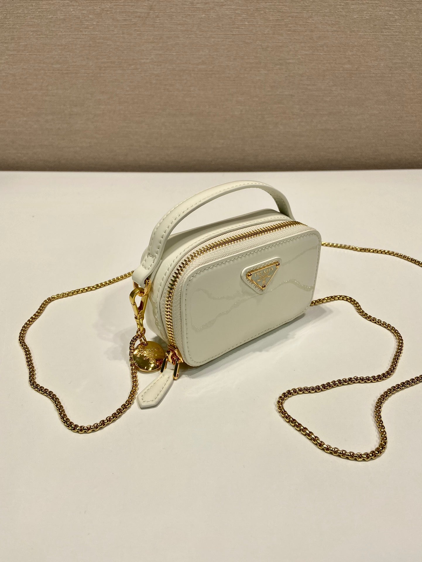 MINI HAND BAG 11 WITH GOLD STRAP IN WHITE PATENT CALFSKIN
