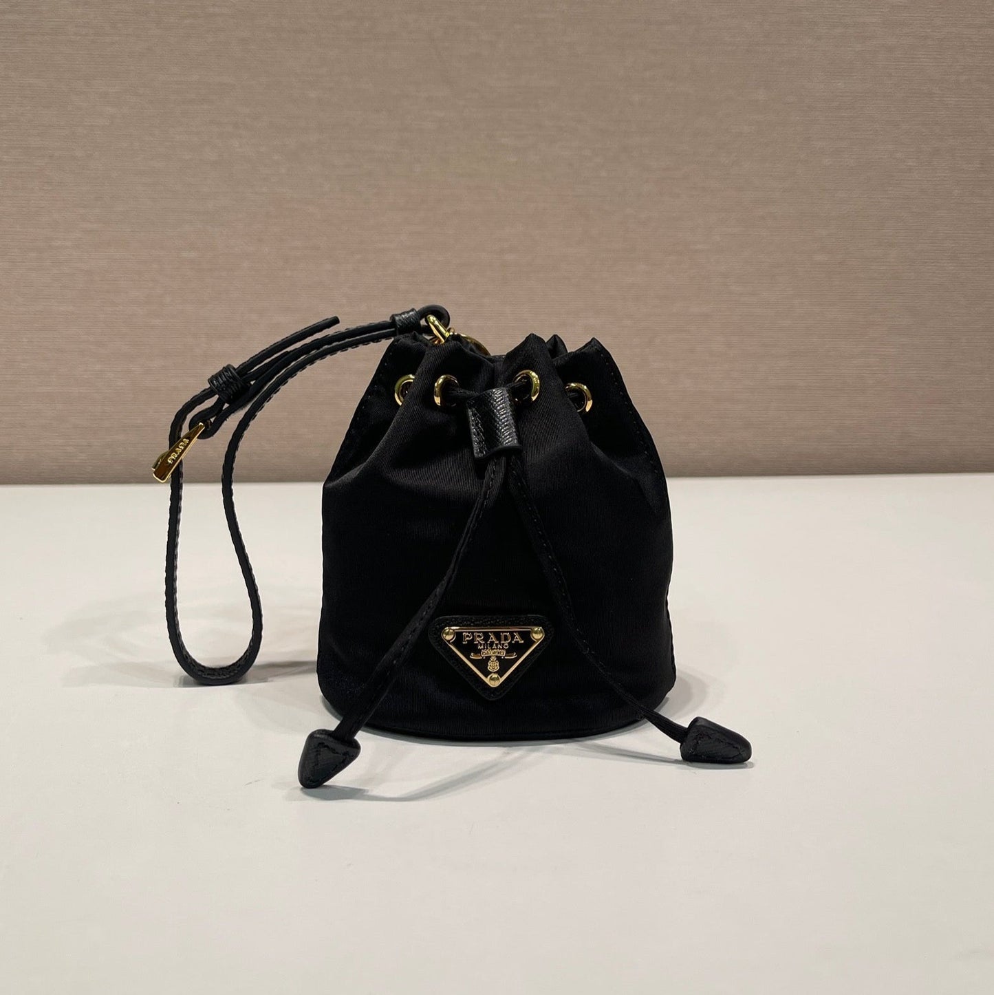 MINI BUCKET BAG 10 IN BLACK RE-NYLON AND SAFFIANO LEATHER STRAP