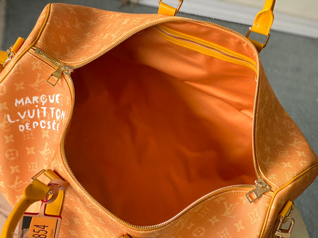 KEEPALL BANDOULI¨¨RE 55 IN ORANGE MONOGRAM HERITAGE CANVAS