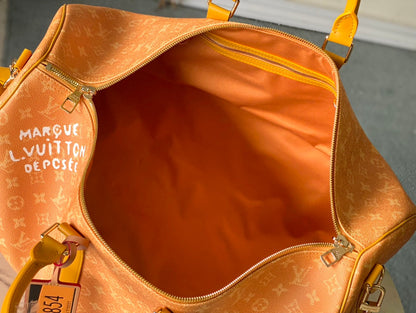 KEEPALL BANDOULI¨¨RE 55 IN ORANGE MONOGRAM HERITAGE CANVAS