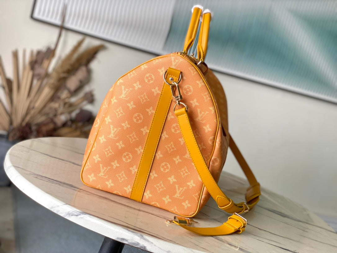 KEEPALL BANDOULI¨¨RE 55 IN ORANGE MONOGRAM HERITAGE CANVAS