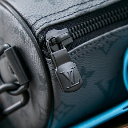 KEEPALL BANDOULI¨¨RE 25 IN GUN METAL MONOGRAM ECLIPSE CANVAS MIX TURQUOISE CALFSKIN
