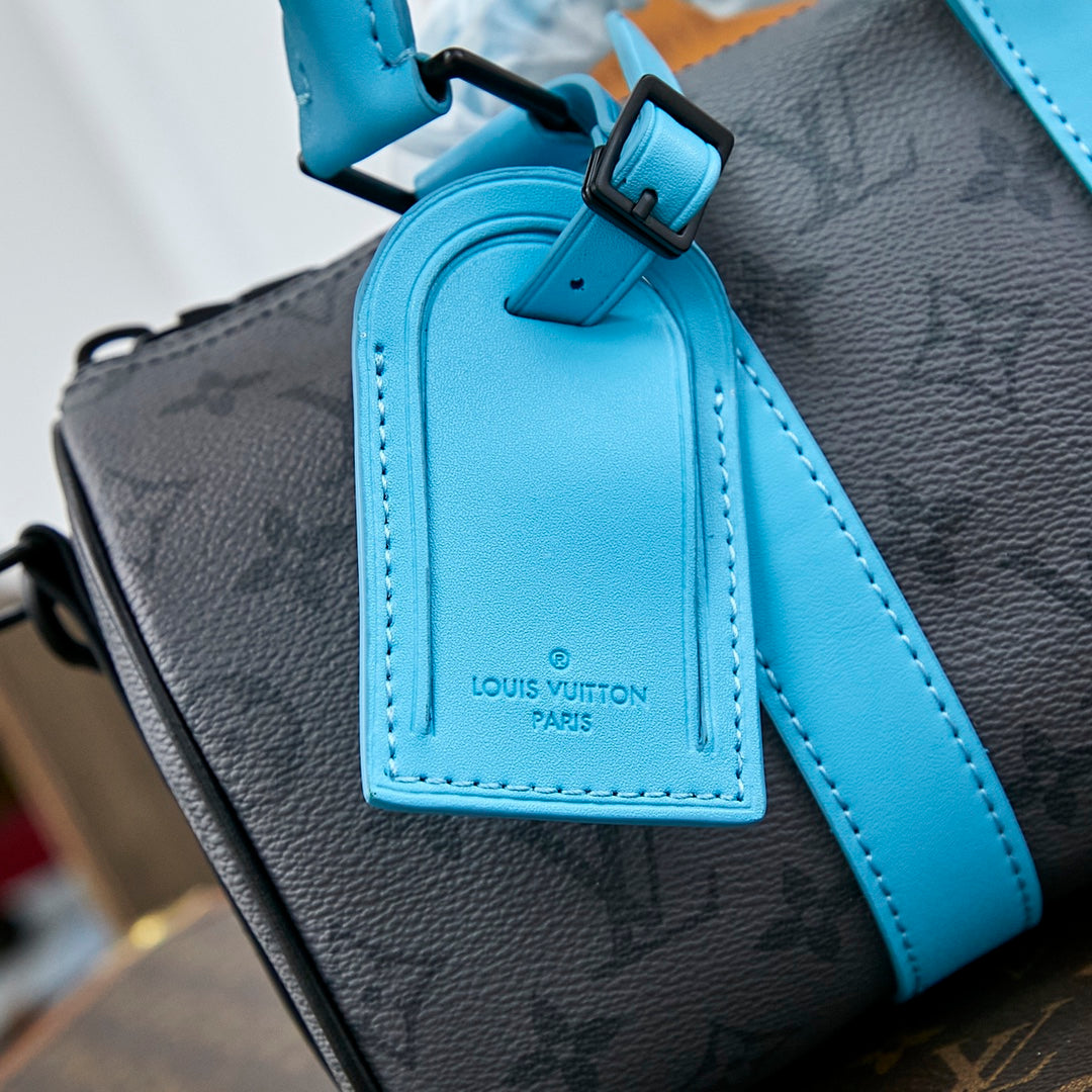 KEEPALL BANDOULI¨¨RE 25 IN GUN METAL MONOGRAM ECLIPSE CANVAS MIX TURQUOISE CALFSKIN